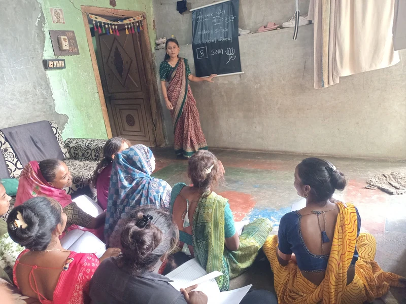 Women taking part in a group literacy lesson in a classroom